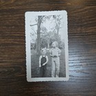 Vintage B w Photo Snapshot Of Young Toddlers Fidgeting With Hands Outside