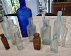 Lot Of 12 Antique Embossed Glass Medicine   Misc  Bottles Vtg