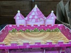 A Fun Pink Dollhouse With Five Barbies And A Set Of Furniture To Go Along