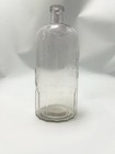 Vintage Clear Glass Bottle With Embossed Text Design 