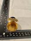 Vintage Ornate Round Gold Toned Metal Pill Box With Central Blue Glass 