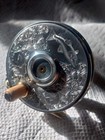 Vintage Engraved Fly Fishing Reel With Fish Motif And Brass Handle