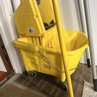 Rubbermaid Brute 16 Oz Wringer Yellow Plastic Rectangular Mop Bucket With Wheels