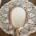 Antique Gold Tone Metal Handheld Vanity Mirror With Ornate Floral Handle