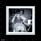 Old Vintage Photo Woman With Glasses And Boy Sitting At Table Square Pic