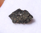  082 Grams Crusted Side 9x5x2mm Murchison Meteorite In A Glass Top Display Case
