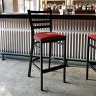 Hercules Black Ladder Back Metal Restaurant Barstool - Red Vinyl Seat
