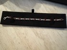 7 25  Garnet And Diamond Accented Infinity Bracelet In Sterling Silver