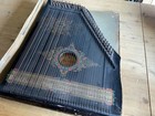 A German Ebonised Zither Instrument  Decorated With Melody Notes And Flowers