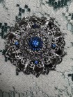 Silver Tone Filigree Round Brooch Pin  Blue Rhinestones  Prong Set  2 5 In