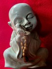 Buddhist Monk Statue With Prayer Beads And Bird Figurine Buddhism
